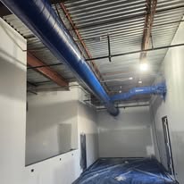 Industrial Ceiling & Blue Ductwork Spray